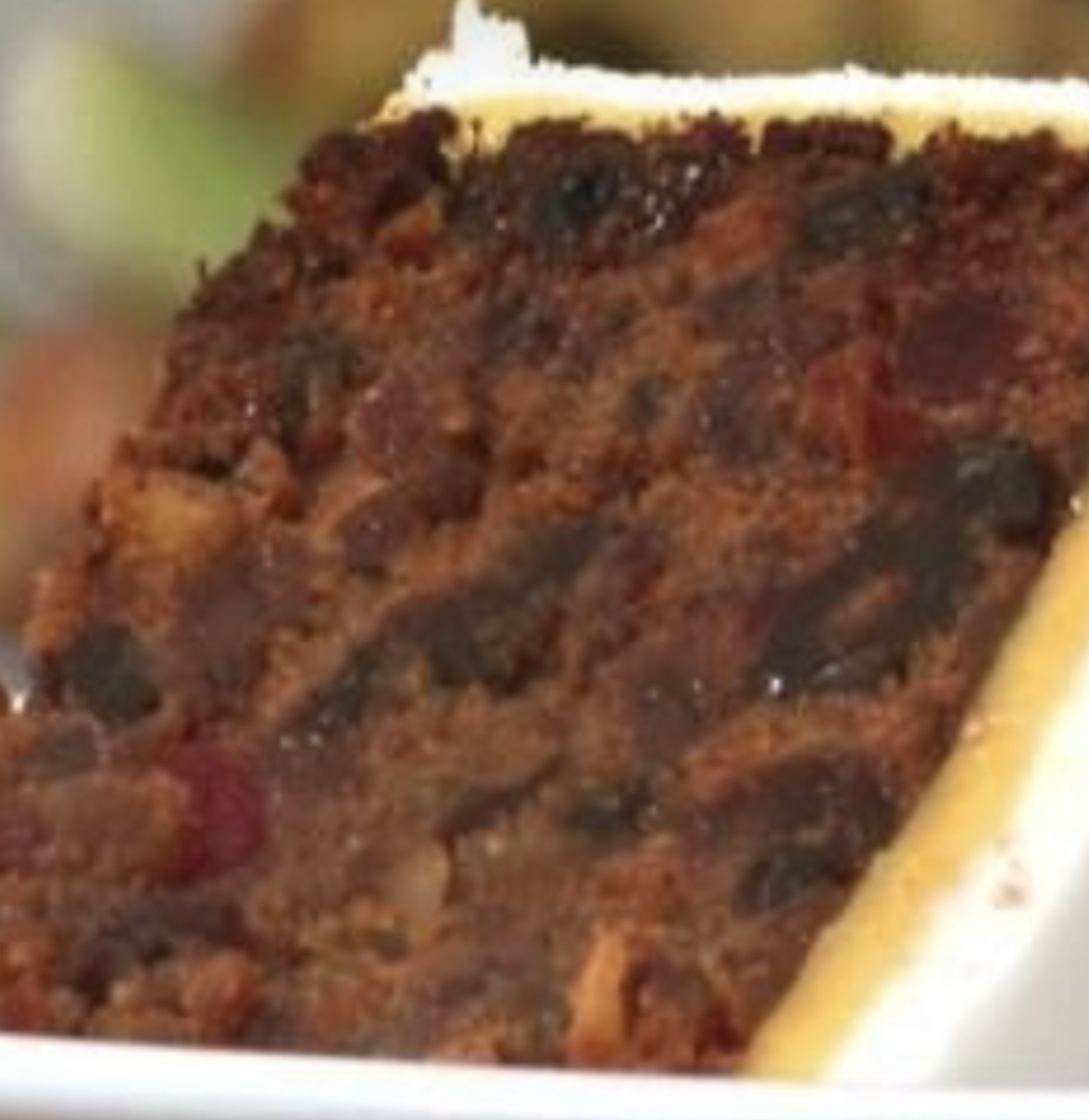 Photo of luxury fruit cake fed with alcohol before covering with marzipan and fondant icing.