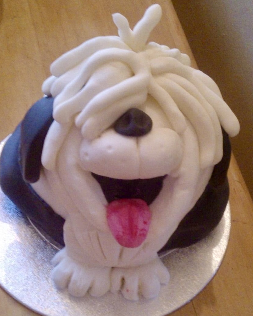 Photo depicts a sponge cake with choice of filling and decorated with fondant to resemble old english sheepdog.