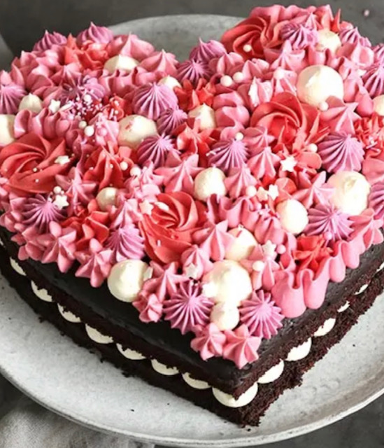 Flavoured sponge cake baked in heart shape and filled with chosen frosting, tipped with meringe kisses and piped flowers.